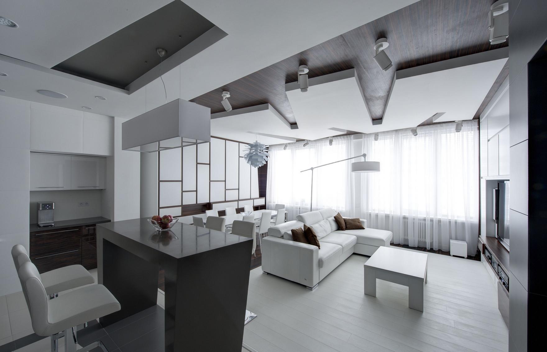 Белая и черная мебель в интерьере гостиной-кухни